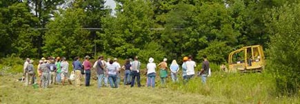 image of people watching inspecting efforts